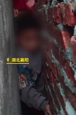 小学生放学回家为抄近道卡墙缝