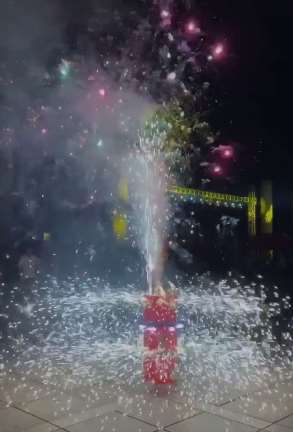 男子广场燃放旋转烟花十分震撼 吸引众人驻足观看